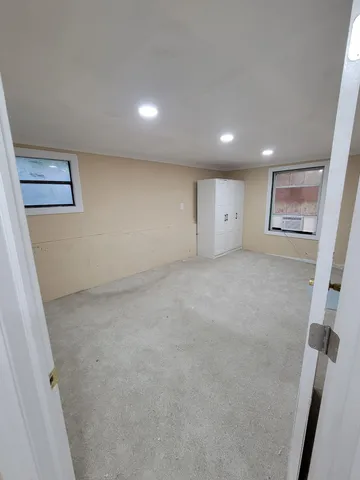 a large kitchen with a large counter top stainless steel appliances and cabinets