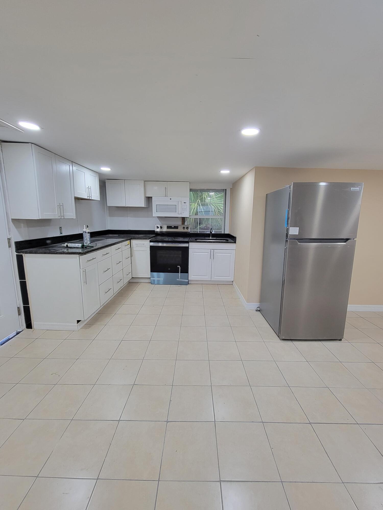 5728 St Lucie Boulevard, Unit REAR HOUSE Fort Pierce, FL 34946 - Photo 16 of 22 a large kitchen with a large counter top stainless steel appliances and cabinets
