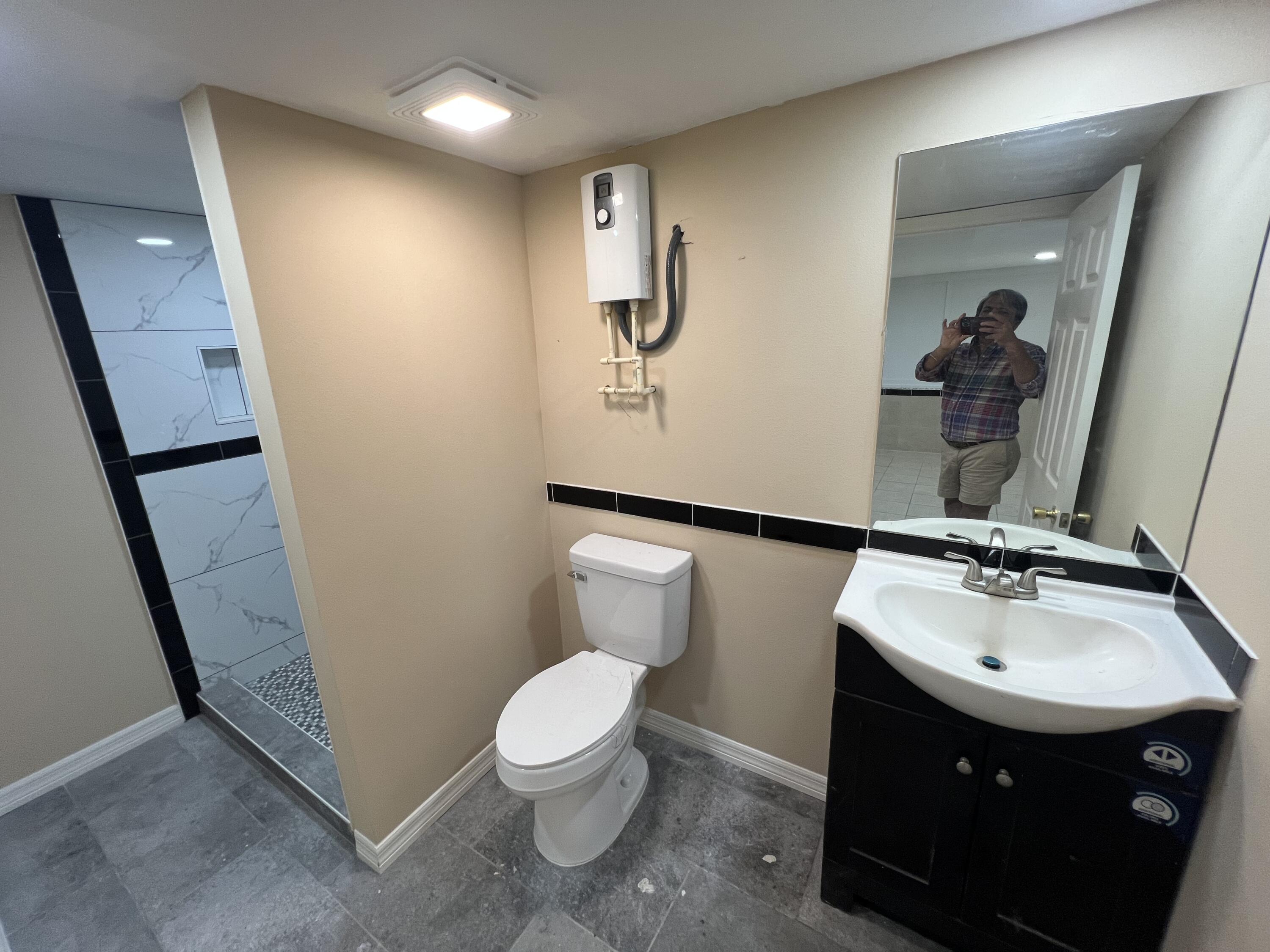 5728 St Lucie Boulevard, Unit REAR HOUSE Fort Pierce, FL 34946 - Photo 17 of 22 a bathroom with a sink and a mirror