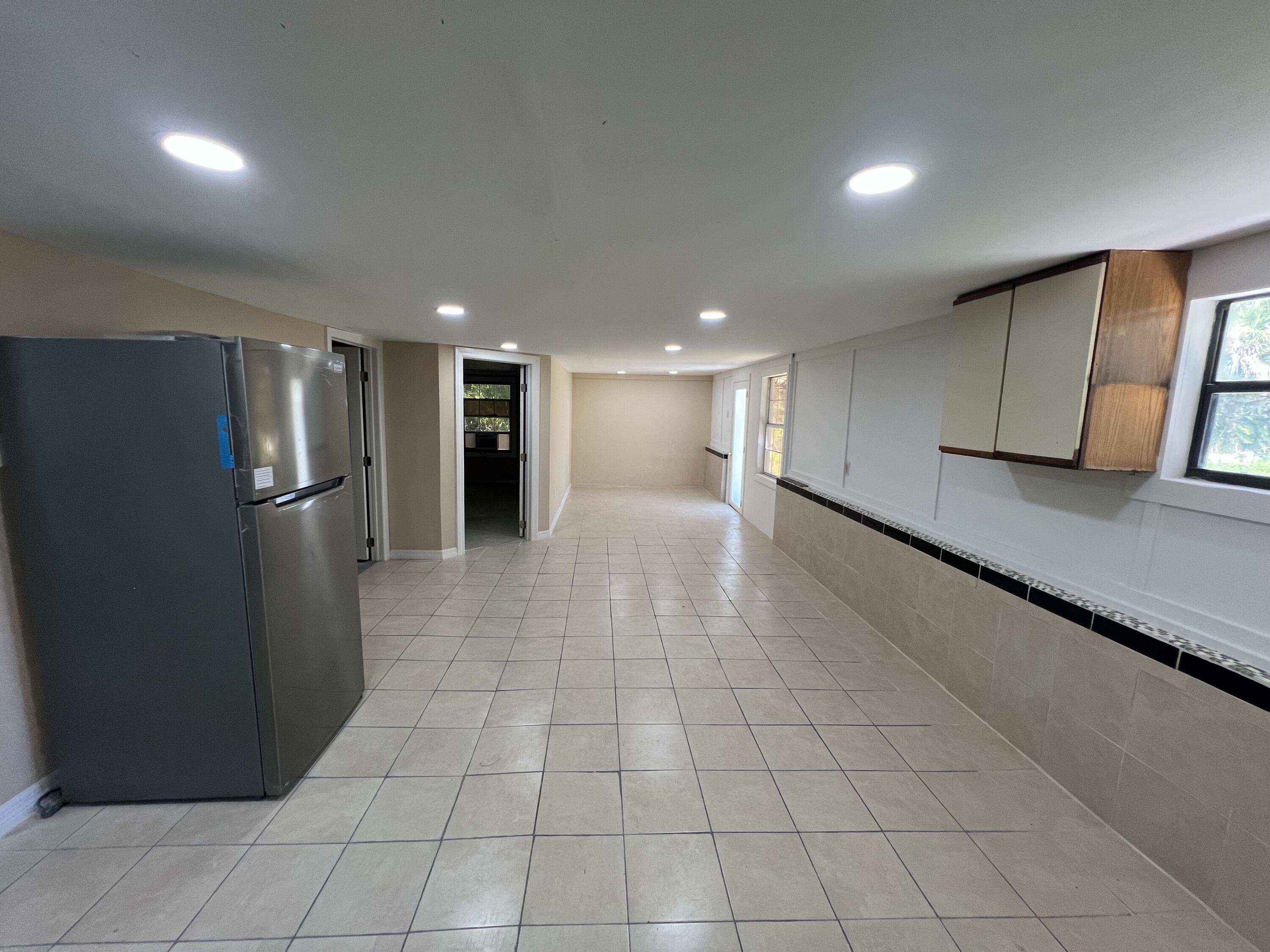 5728 St Lucie Boulevard, Unit REAR HOUSE Fort Pierce, FL 34946 - Photo 19 of 22 a view of an empty room with wooden floor