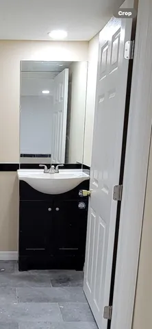 a bathroom with a sink a mirror and vanity