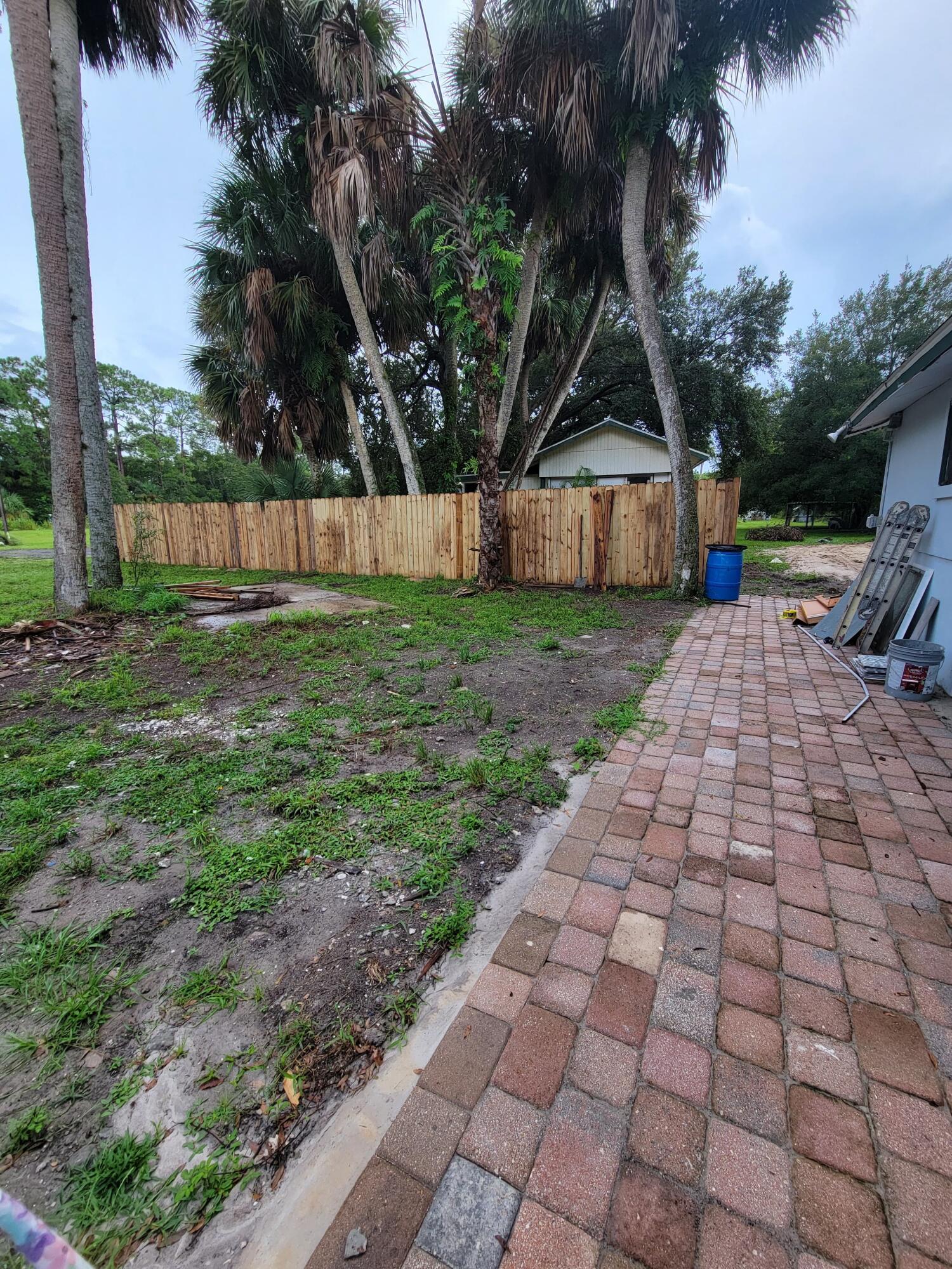 5728 St Lucie Boulevard, Unit REAR HOUSE Fort Pierce, FL 34946 - Photo 6 of 22 a view of a backyard with large trees