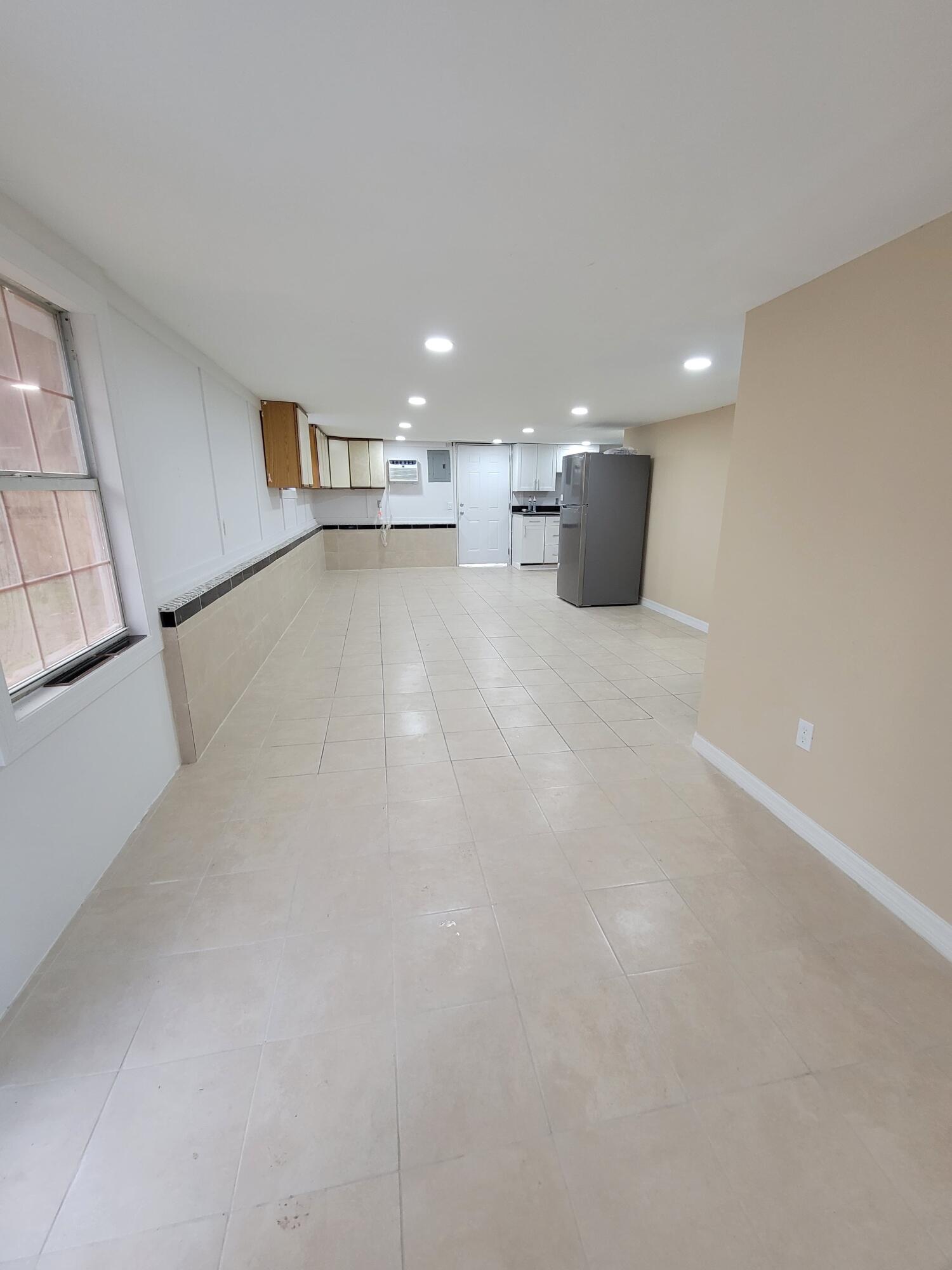 5728 St Lucie Boulevard, Unit REAR HOUSE Fort Pierce, FL 34946 - Photo 9 of 22 a view of empty room with kitchen and window