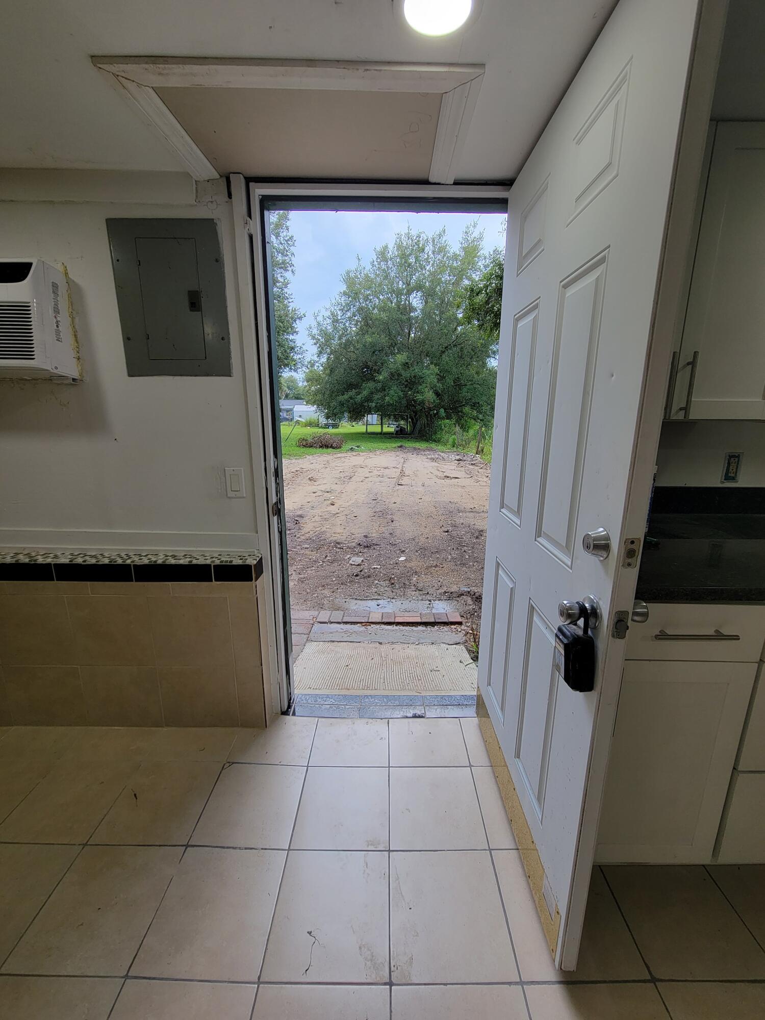 5728 St Lucie Boulevard, Unit REAR HOUSE Fort Pierce, FL 34946 - Photo 10 of 22 a view of a refrigerator in a kitchen