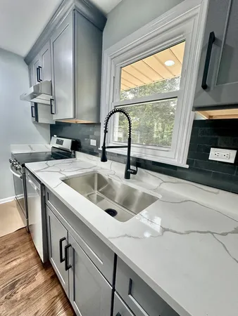 a kitchen with a sink and a stove