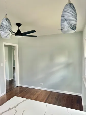 a view of a room with wooden floor and a window
