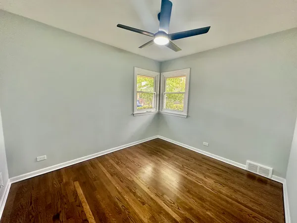 a bathroom with a toilet sink mirror and shower