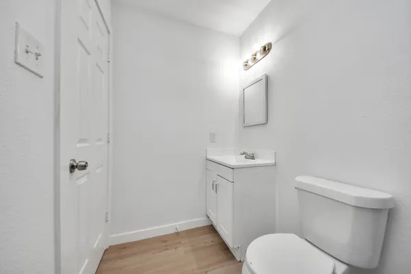 a bathroom with a toilet a sink and mirror
