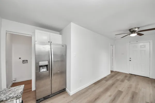 a view of a refrigerator in kitchen and wooden floor