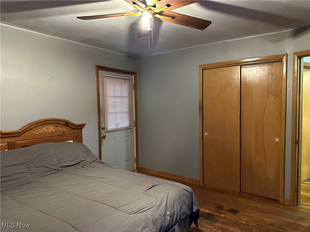 12303 Orme Road Garfield Heights, OH 44125 - Photo 12 of 22 Bedroom with a closet, baseboards, wood finished floors, and a ceiling fan
