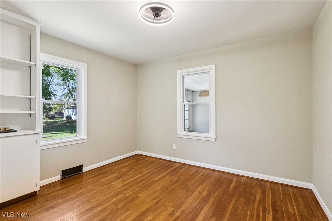 5898 Keller Road Akron, OH 44319 - Photo 20 of 32 Unfurnished room featuring baseboards and wood finished floors