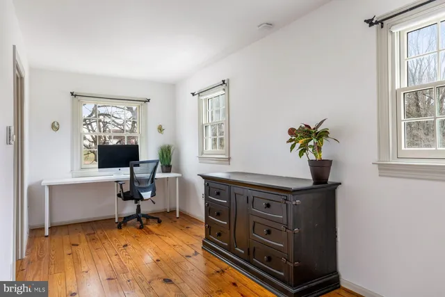 a bedroom with furniture and a wooden floor
