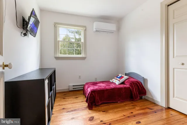 a bedroom with a bed and flat screen tv