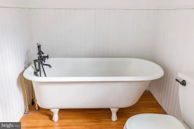 a living room with a bed and a window