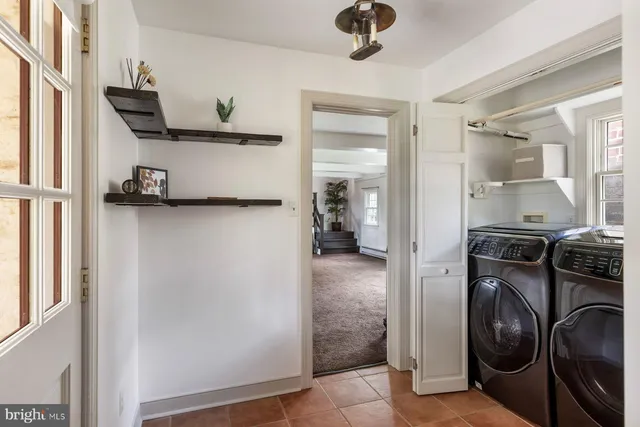 a kitchen with a refrigerator and a stove top oven