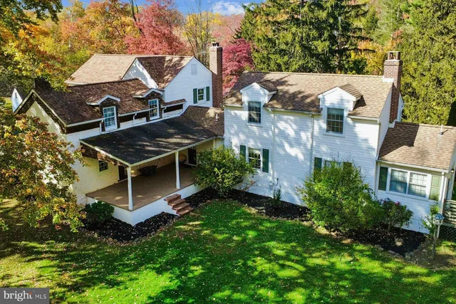 a view of a house with a tree in the background