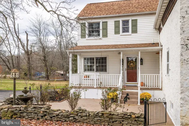 a kitchen with stainless steel appliances granite countertop a sink a stove a refrigerator cabinets and a window