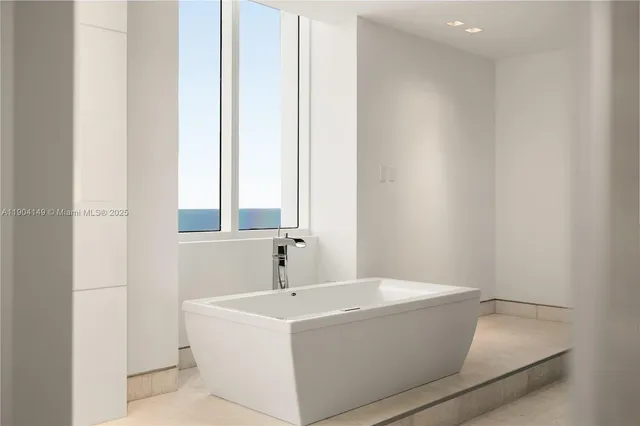 a white bath tub sitting next to a white sink