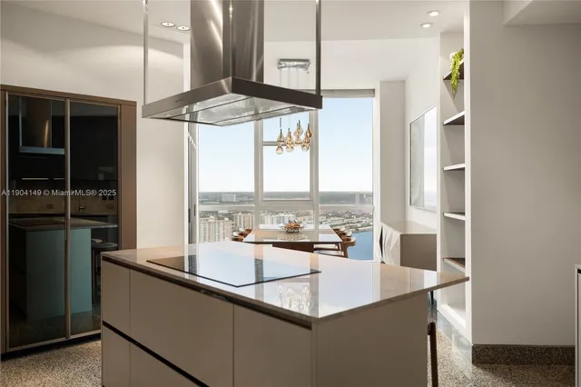 a kitchen with a sink a counter top space and stainless steel appliances