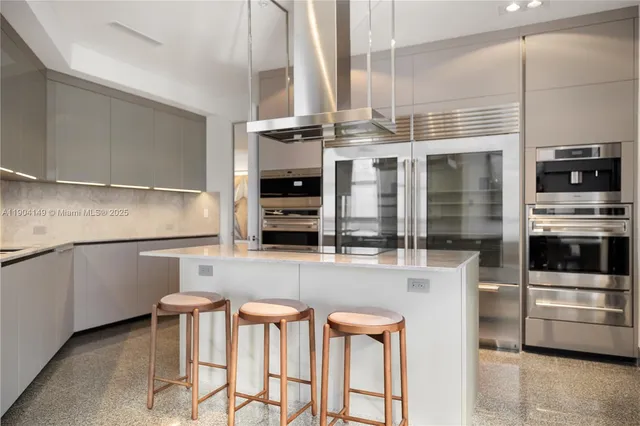 a kitchen with stainless steel appliances a stove a sink and a microwave