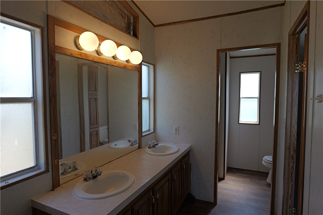 732 A Rogers Street Normangee, TX 77871 - Photo 5 of 8 a bathroom with a sink and a mirror