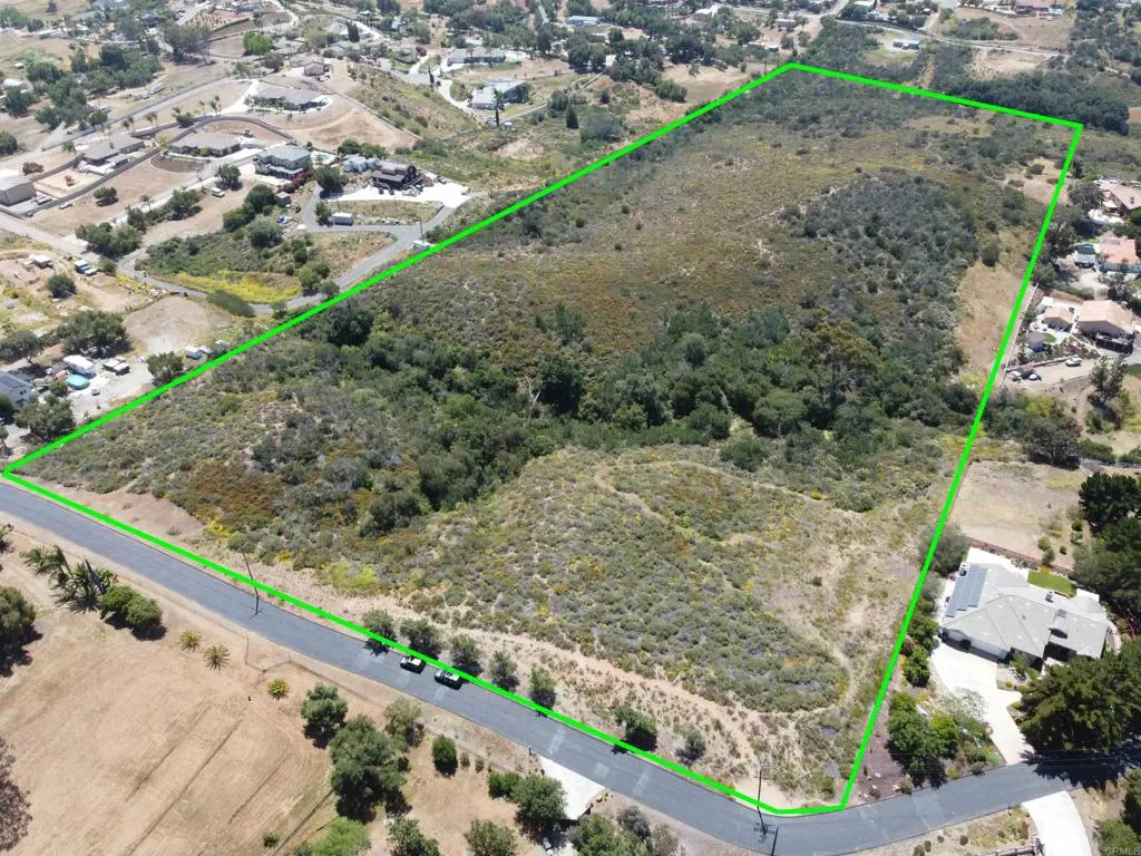 a view of a yard with wooden fence