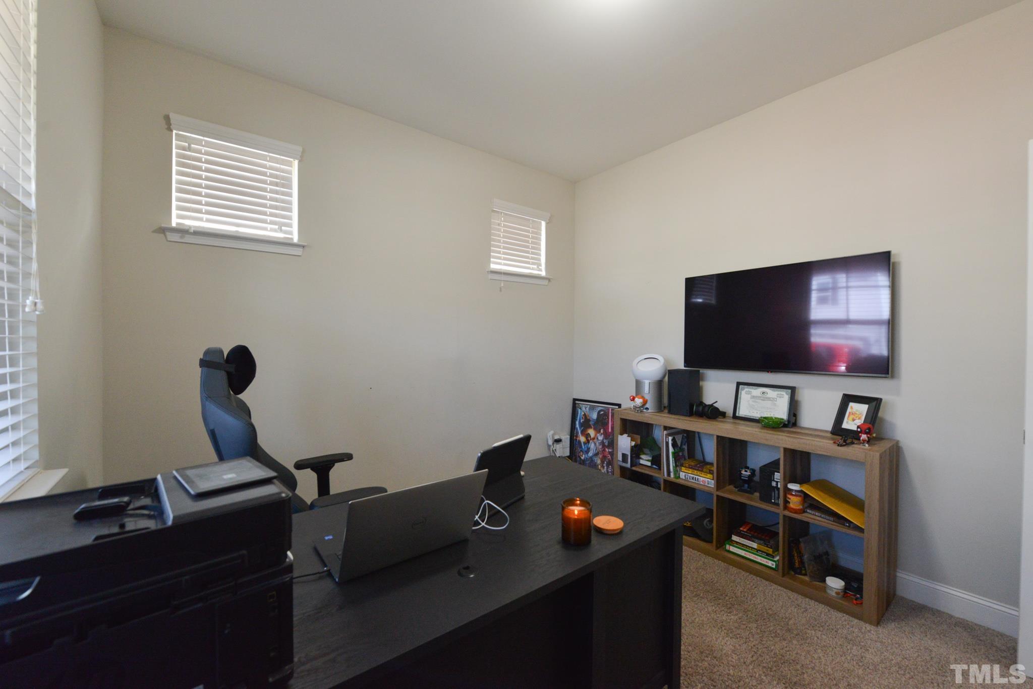 60 Mariners Point Way Garner, NC 27529 - Photo 19 of 43 a room with furniture and a flat screen tv