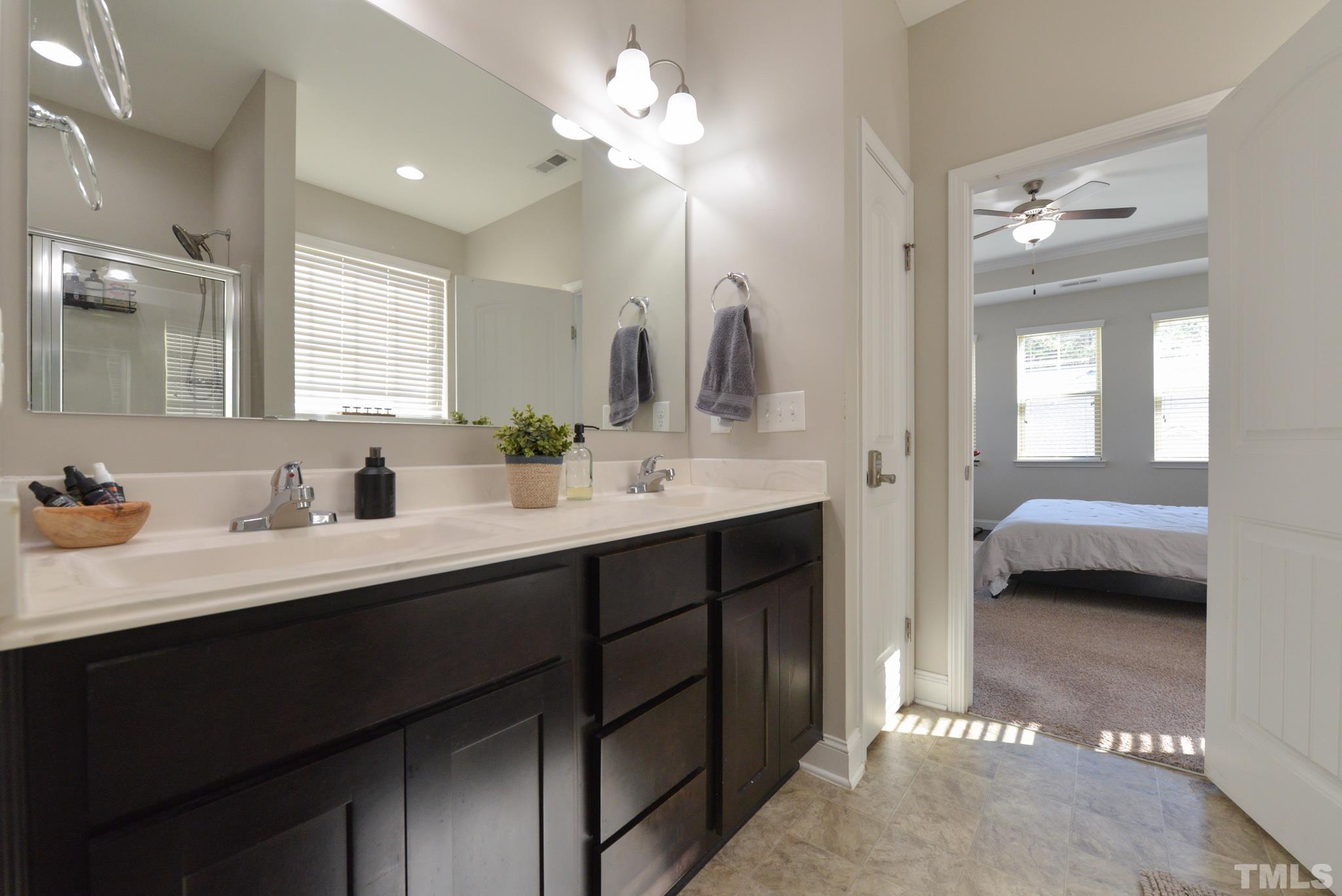 60 Mariners Point Way Garner, NC 27529 - Photo 24 of 43 a en suite bathroom with a double vanity sink and a mirror