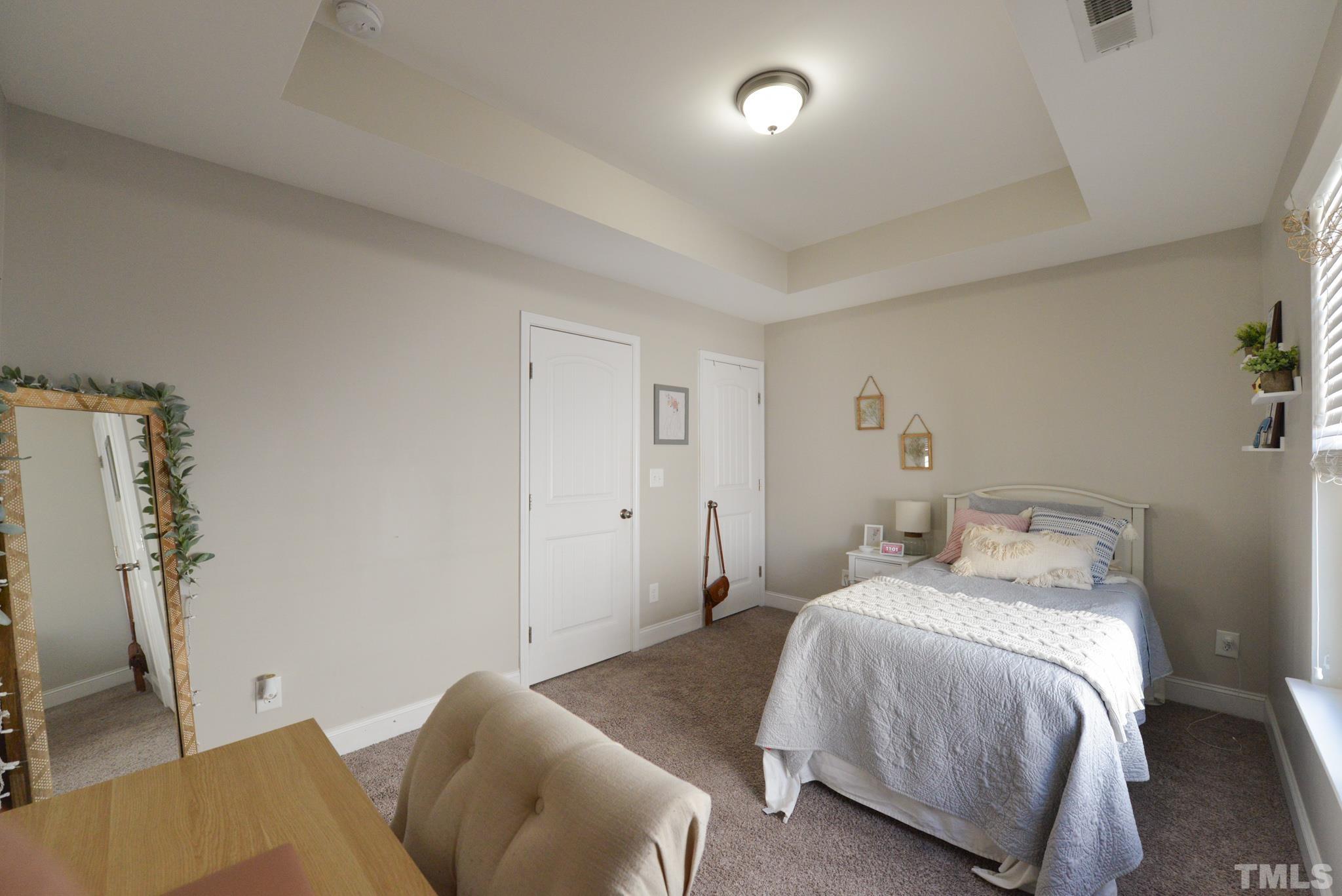 60 Mariners Point Way Garner, NC 27529 - Photo 28 of 43 a bedroom with a bed and wooden floor