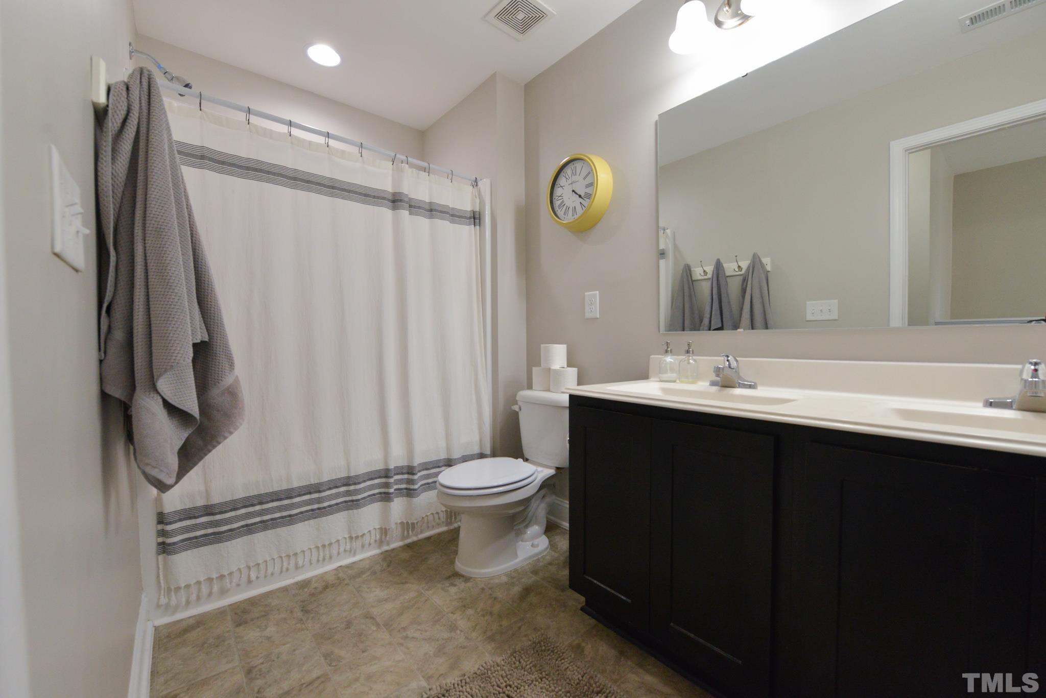 60 Mariners Point Way Garner, NC 27529 - Photo 30 of 43 a bathroom with a sink a toilet and a mirror