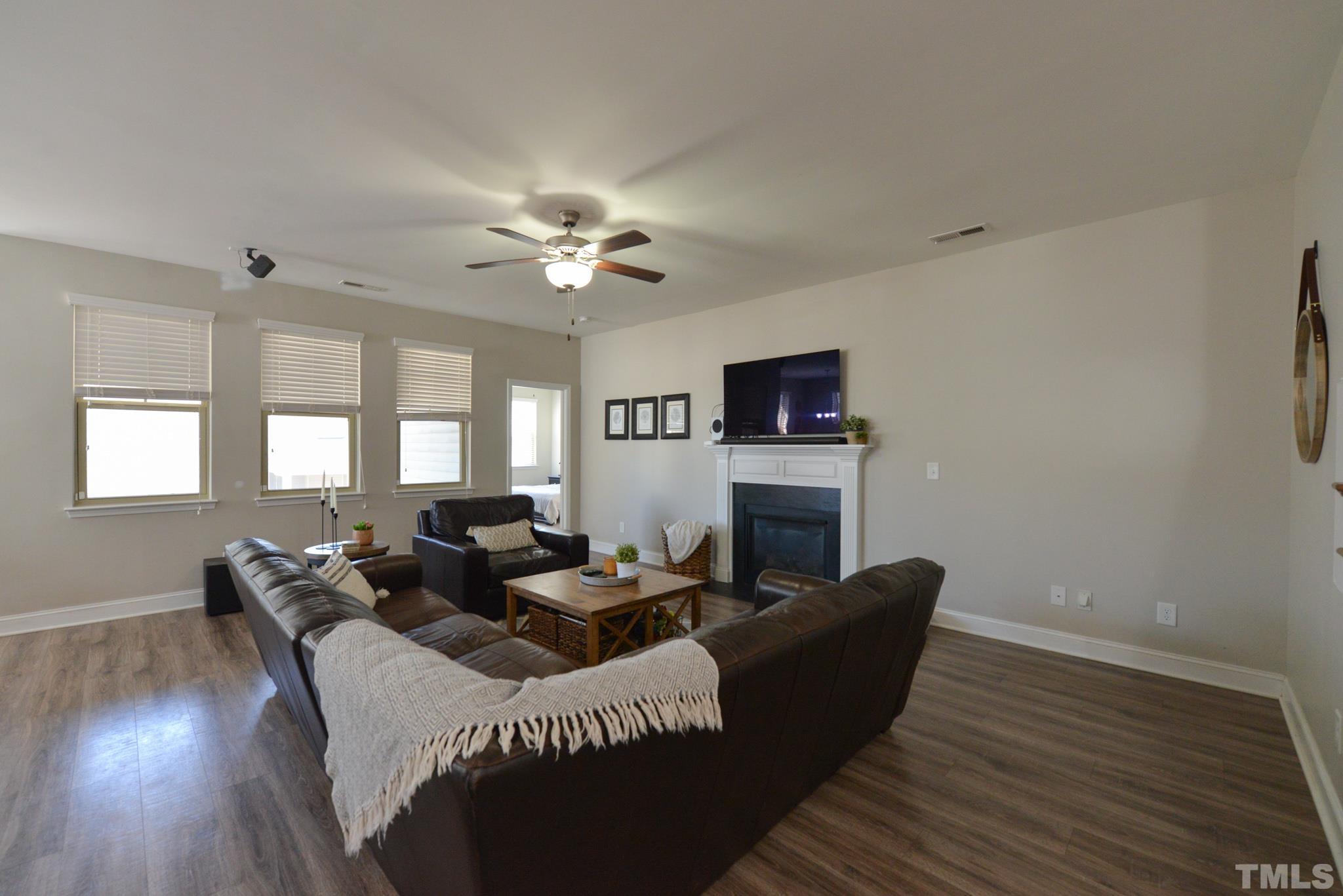60 Mariners Point Way Garner, NC 27529 - Photo 4 of 43 a living room with furniture wooden floor and a fireplace