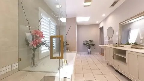 a large white kitchen with a sink and cabinets