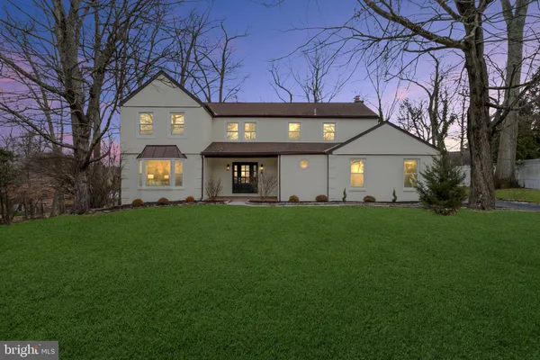 a front view of a house with a garden and yard