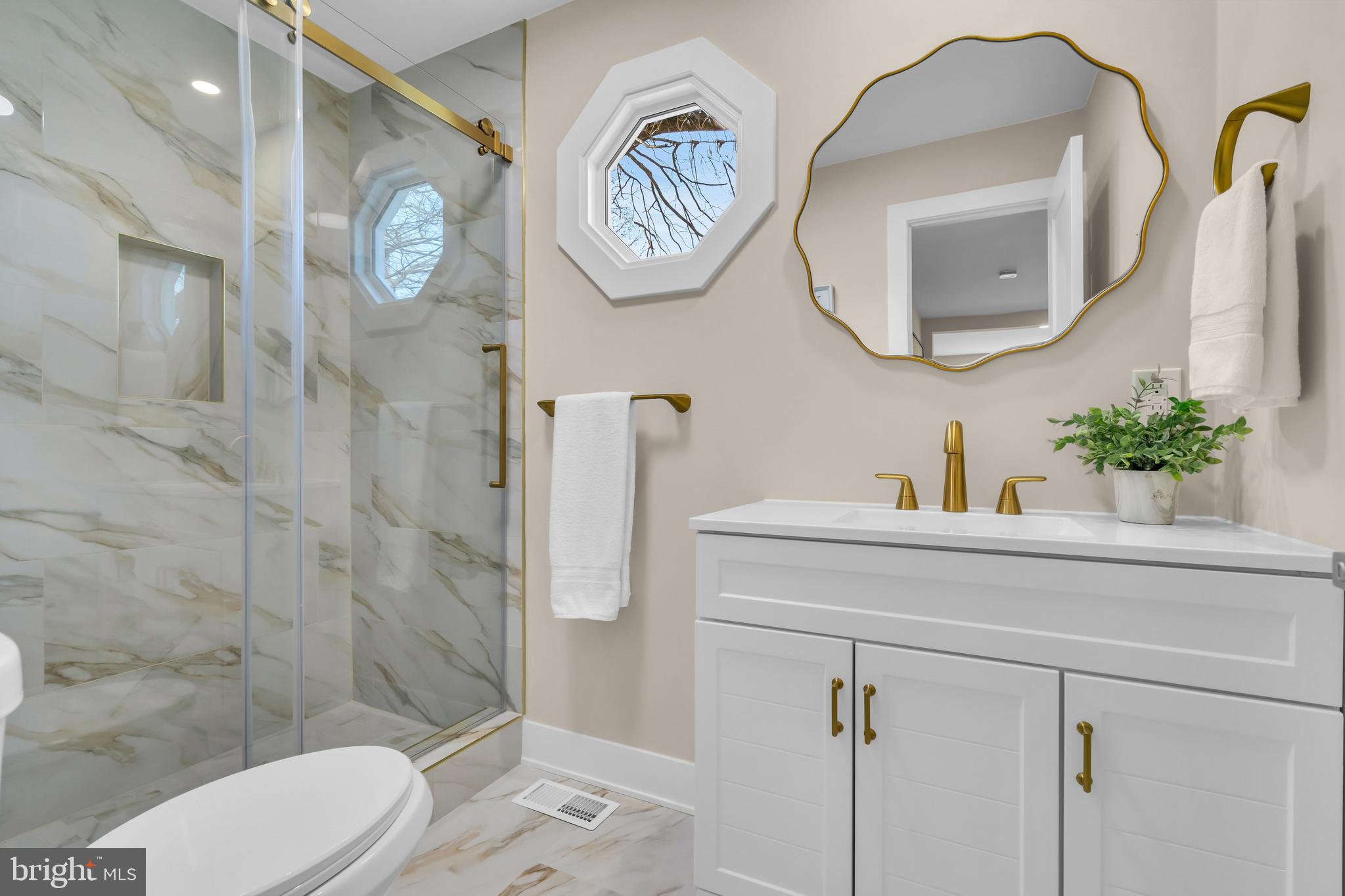 2227 Sand Trap Road Jamison, PA 18929 - Photo 38 of 79 a bathroom with a toilet sink and mirror