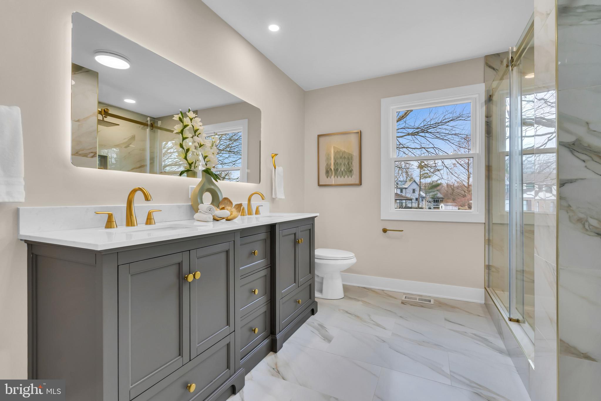 2227 Sand Trap Road Jamison, PA 18929 - Photo 60 of 79 a spacious bathroom with a double vanity sink a large mirror a toilet and a shower