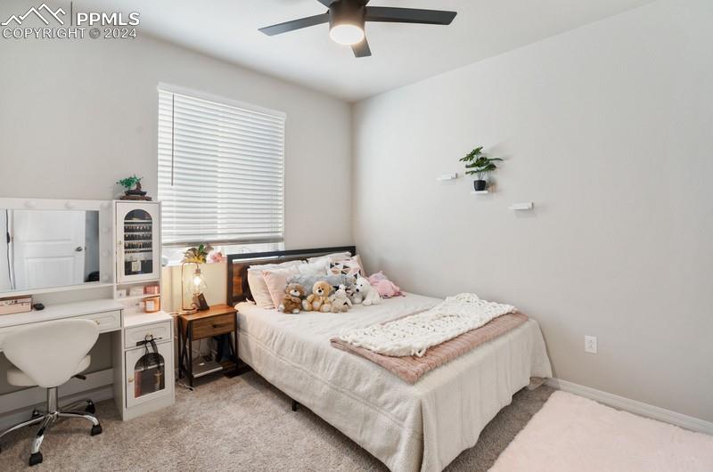 10480 Summer Ridge Drive Peyton, CO 80831 - Photo 21 of 30 a bedroom with a bed and a table in it