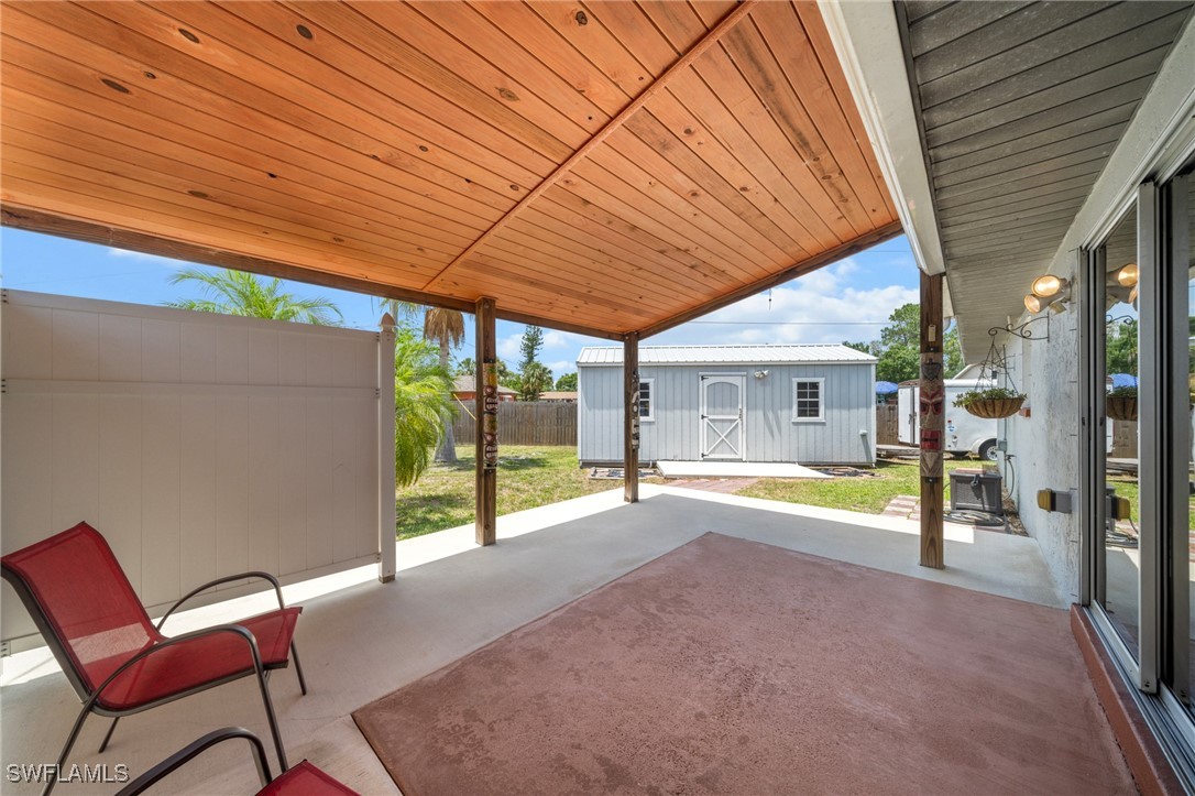 2551 Barcelona Avenue Fort Myers, FL 33905 - Photo 14 of 41 a view of a patio with a table and chairs under an umbrella