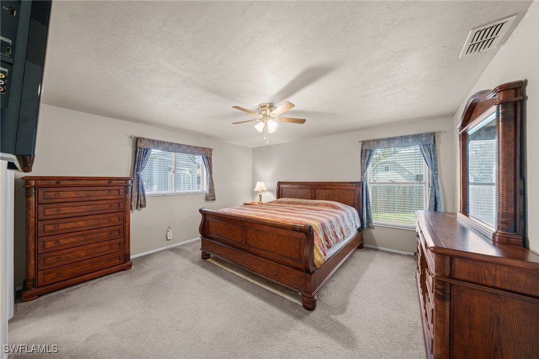 2551 Barcelona Avenue Fort Myers, FL 33905 - Photo 16 of 41 a spacious bedroom with a bed and a dresser