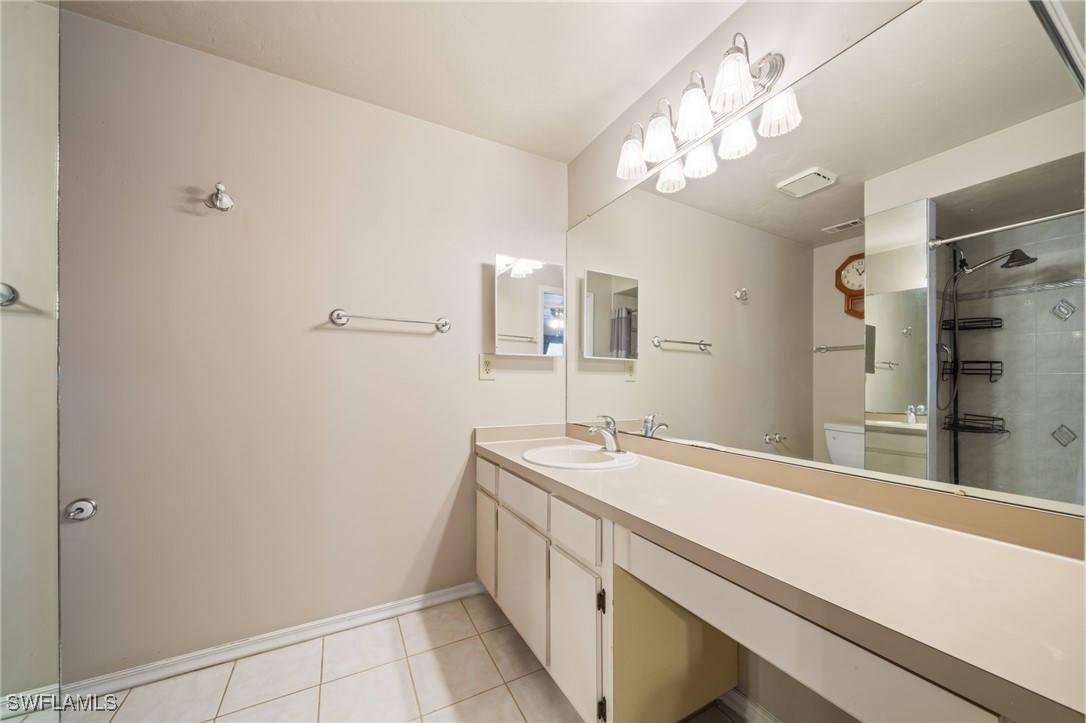 2551 Barcelona Avenue Fort Myers, FL 33905 - Photo 17 of 41 a bathroom with a sink a large mirror and a shower