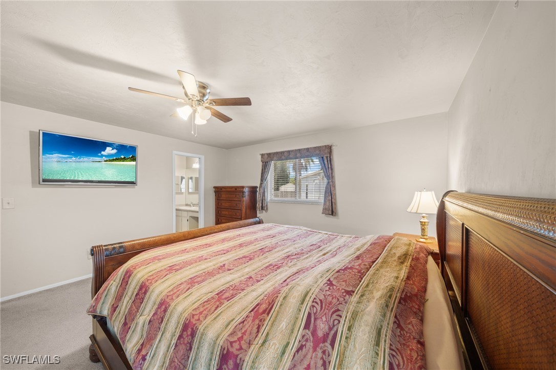 2551 Barcelona Avenue Fort Myers, FL 33905 - Photo 19 of 41 a bedroom with a bed and a chandelier