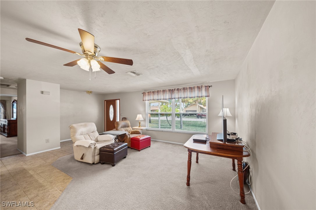 2551 Barcelona Avenue Fort Myers, FL 33905 - Photo 3 of 41 a living room with furniture and a large window