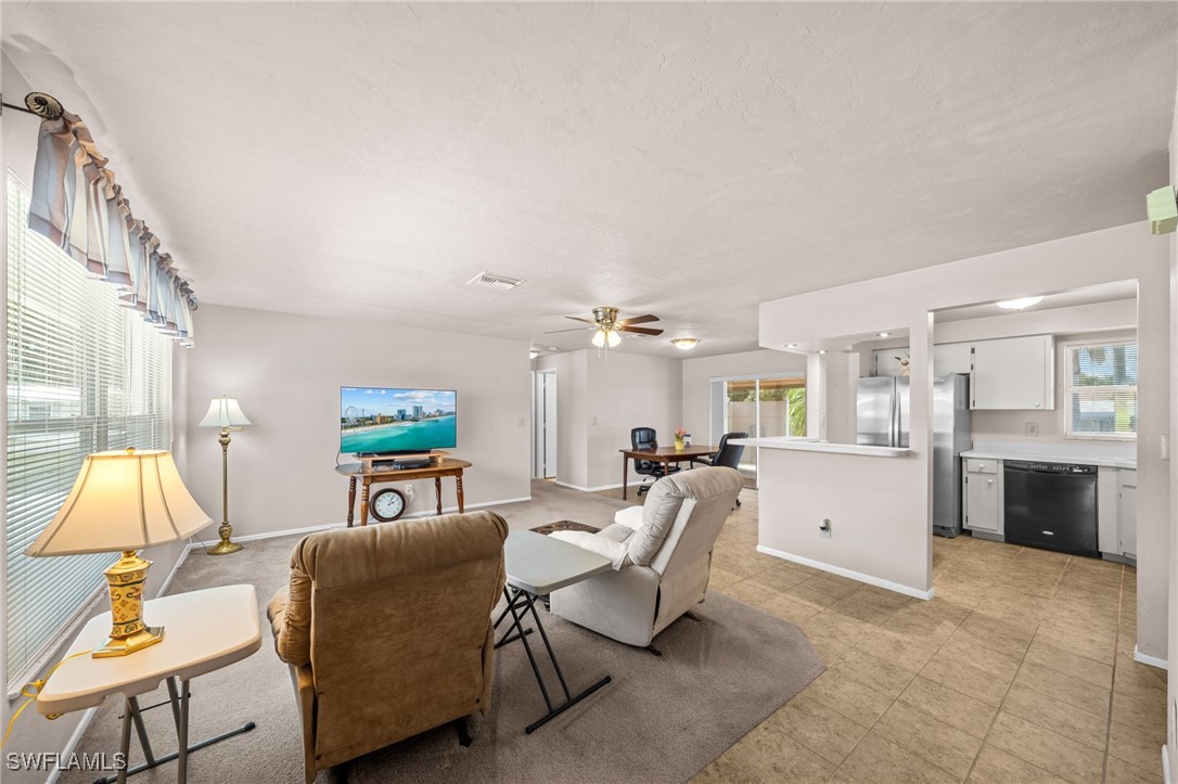 2551 Barcelona Avenue Fort Myers, FL 33905 - Photo 5 of 41 a living room with furniture and a flat screen tv