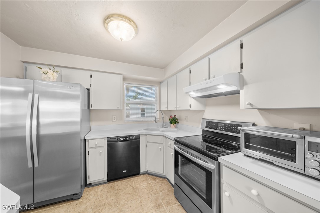 2551 Barcelona Avenue Fort Myers, FL 33905 - Photo 7 of 41 a kitchen with cabinets stainless steel appliances and a counter space