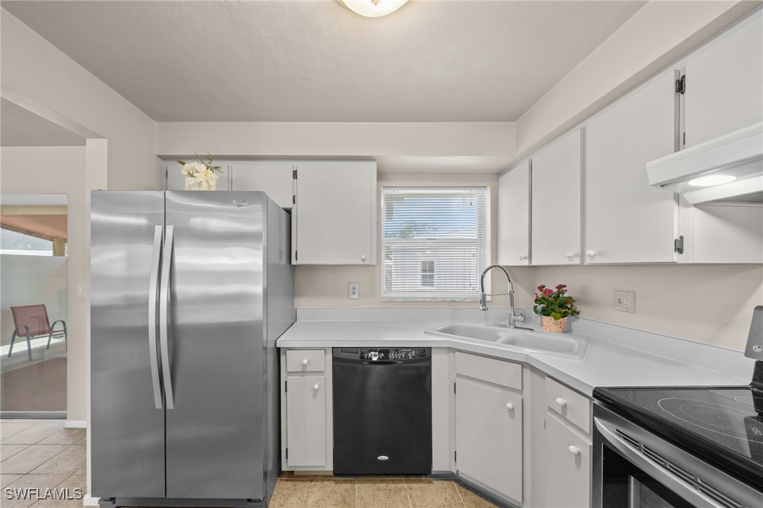 2551 Barcelona Avenue Fort Myers, FL 33905 - Photo 8 of 41 a kitchen with a refrigerator and a sink