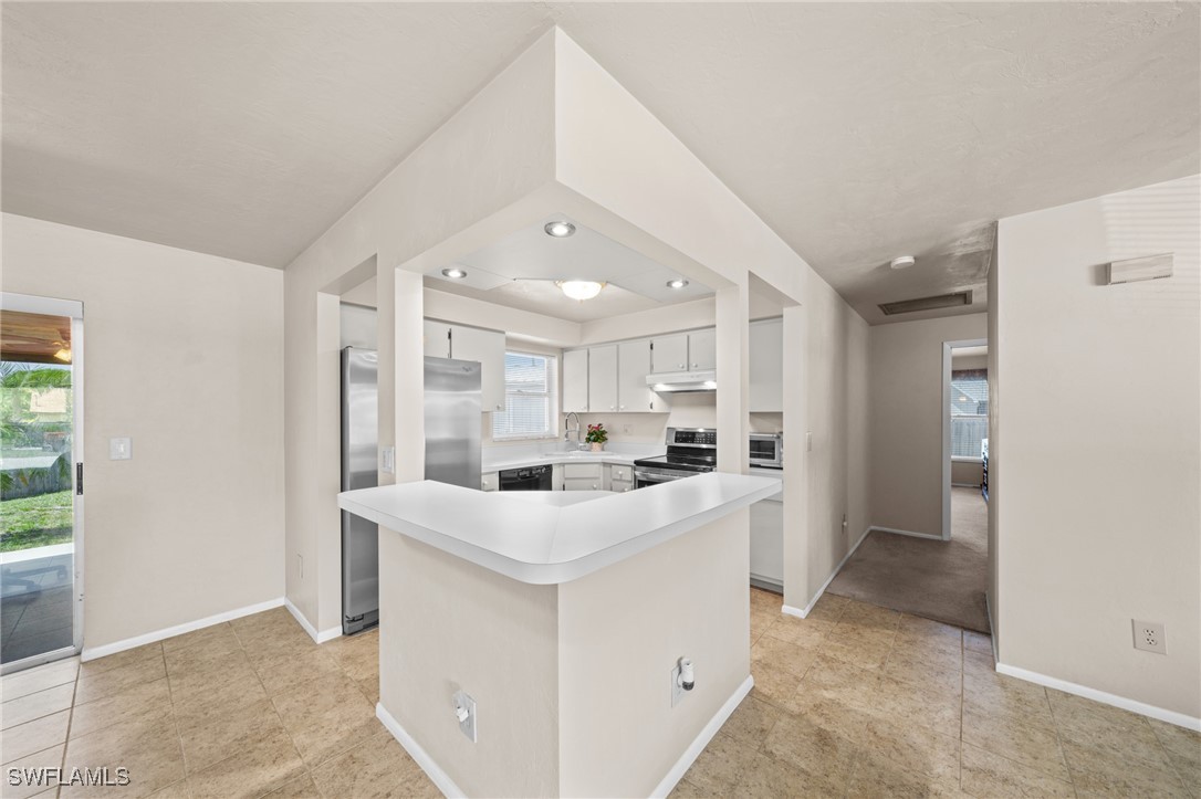 2551 Barcelona Avenue Fort Myers, FL 33905 - Photo 10 of 41 a kitchen with white cabinets and white appliances