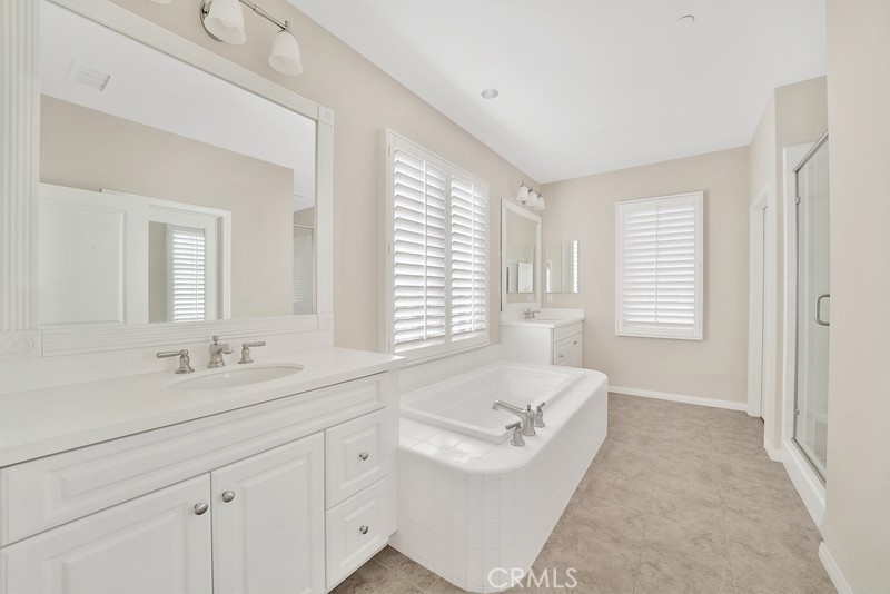 45 Cipresso Irvine, CA 92618 - Photo 20 of 30 a spacious bathroom with sinks mirror and a bathtub