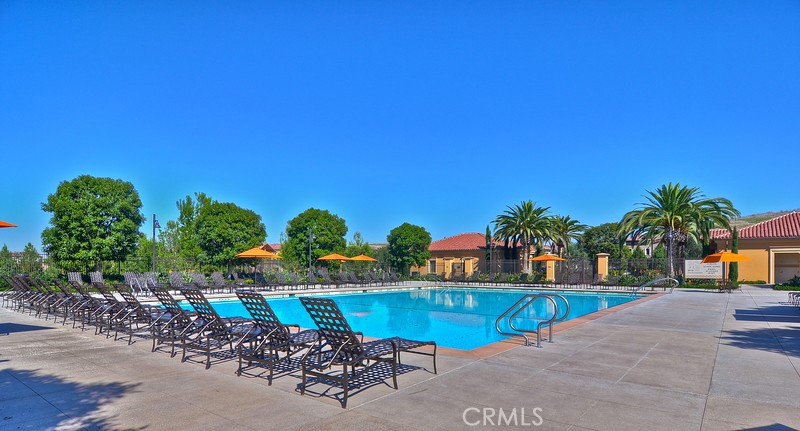 45 Cipresso Irvine, CA 92618 - Photo 27 of 30 a view of a swimming pool with a lawn chairs under an umbrella
