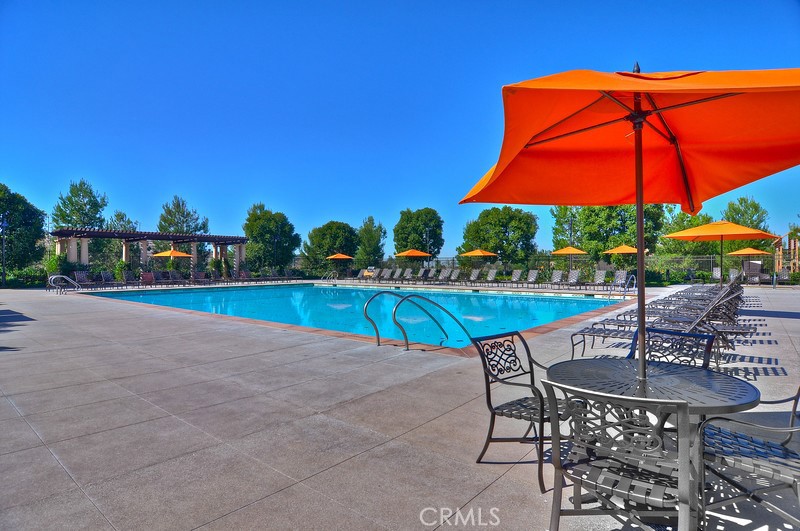45 Cipresso Irvine, CA 92618 - Photo 28 of 30 a view of patio with chairs and table under an umbrella