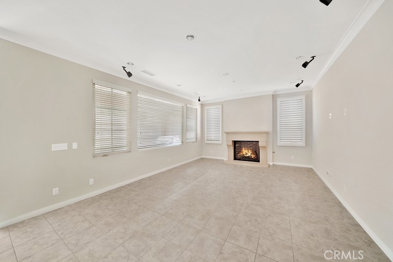 45 Cipresso Irvine, CA 92618 - Photo 3 of 30 a view of an empty room with a fireplace and a window