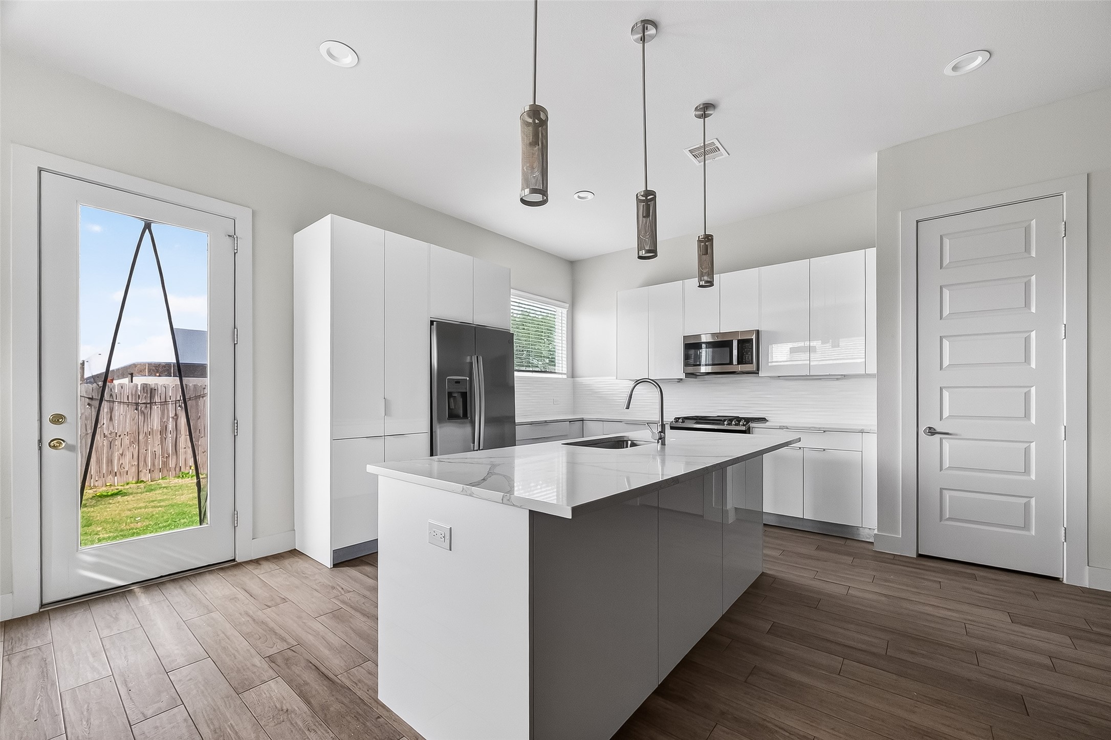 5703 Pampero Lane Houston, TX 77092 - Photo 12 of 41 a kitchen with kitchen island granite countertop a sink a counter space appliances and cabinets